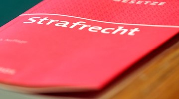 Ein Buch «Strafrecht» liegt vor Prozess-Beginn im Saal des Landgerichts. Foto: Malte Christians/dpa/Symbolbild