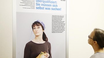 Eine Besucherin vor einem Objekt der Wanderausstellung «Schicksal Treuhand - Treuhand-Schicksale». Foto: Bodo Schackow/zb/dpa/Archivbild