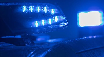 Blaulichter leuchten auf einem Streifenwagen der Polizei. Foto: Jens Büttner/zb/dpa/Archivbild