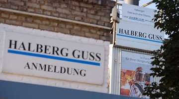 Ein Schild mit dem Namen Halberg Guss. Foto: Oliver Dietze/dpa/Archiv