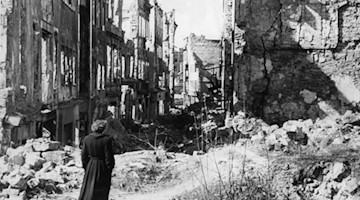 Eine Frau geht durch das im Zweiten Weltkrieg zerstörte Dresden (undatierte historische Aufnahme). Foto: picture alliance / dpa