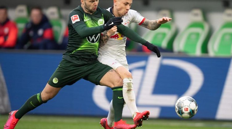 Wolfsburgs Renato Steffen und Leipzigs Angelino (l-r.) im Duell um den Ball. Foto: Swen Pförtner/dpa