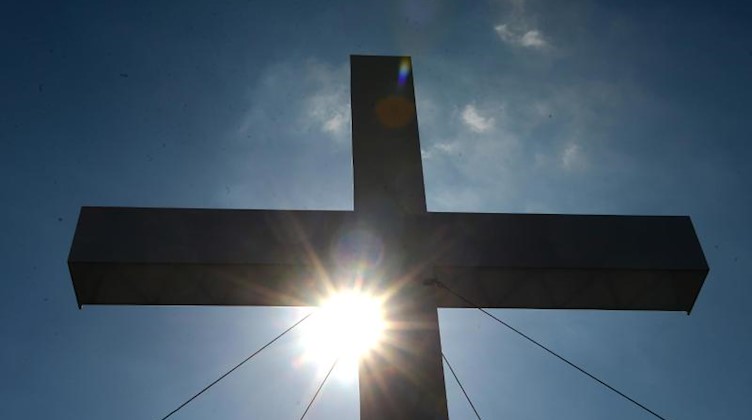 Ein riesiges Kreuz ist während eines Gottesdienstes zu sehen. Foto: Marcus Brandt/dpa/Archivbild