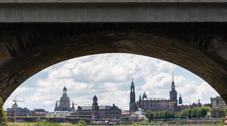 Blick durch einen Brückenbogen der Marienbrücke auf die historische Altstadtkulisse an der Elbe. Foto: Robert Michael/dpa-Zentralbild/dpa