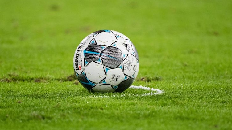 Ein Fußball liegt auf dem Rasen. Foto: Matthias Balk/dpa/Symbolbild