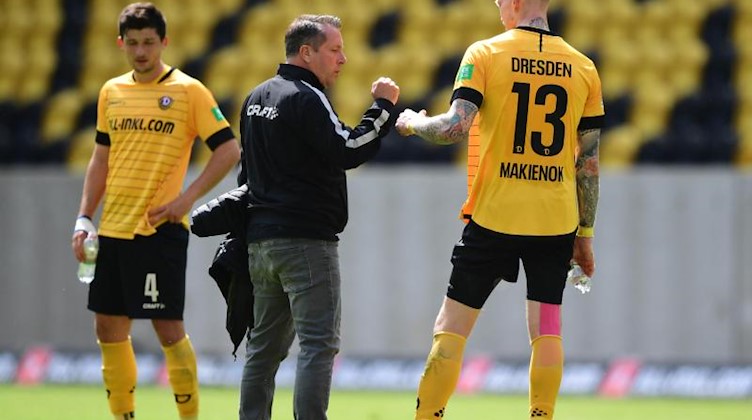 Trainer Markus Kauczinski von Dresden klatscht mit Simon Makienok nach dem Spiel ab. Foto: Robert Michael/dpa-Pool/dpa
