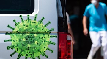 Ein Arzt geht an einem Corona-Testmobil vorbei. Foto: Nicolas Armer/dpa/Symbolbild