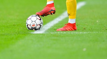 Ein Fußballer kickt den Ball. Foto: Uwe Anspach/dpa/Symbolbild