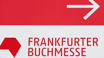 Das Logo der Frankfurter Buchmesse auf einem Wegweiser auf dem Messegelände. Foto: Silas Stein/dpa/Archivbild/Symbolbild