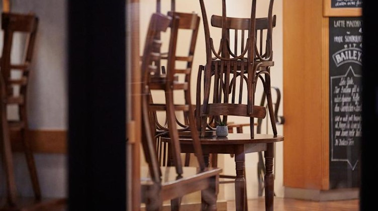 Die Stühle in einem geschlossenen Lokal sind hochgestellt. Foto: Henning Kaiser/dpa/Symbolbild