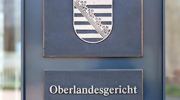 Ein Aufsteller mit dem Wappen von Sachsen und der Aufschrift «Oberlandesgericht». Foto: Robert Michael/zb/dpa