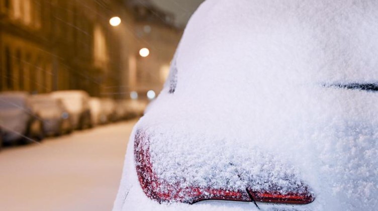 Schnee liegt auf Autos und in den Straßen. Foto: Hendrik Schmidt/dpa-Zentralbild/dpa