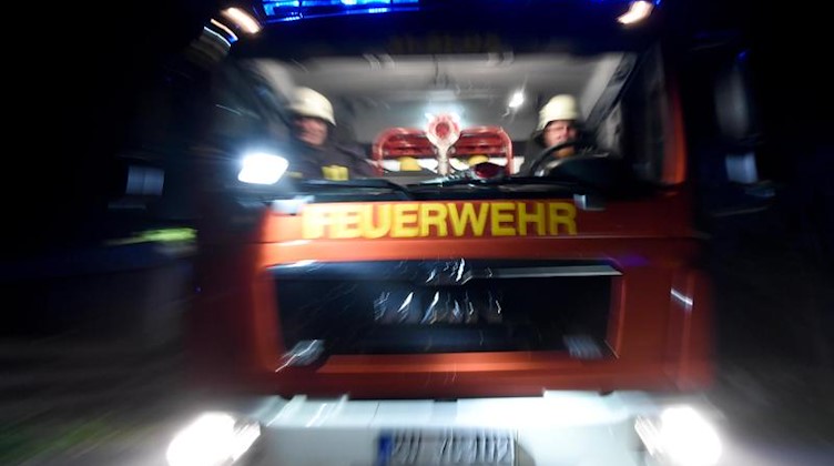 Ein Löschfahrzeug fährt mit Blaulicht über eine Straße. Foto: Carsten Rehder/dpa/Symbolbild
