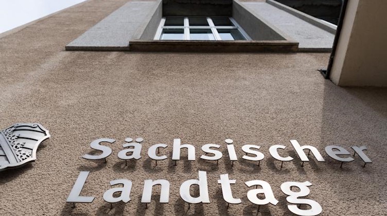 Ein Sachsen-Wappen und der Schriftzug Sächsischer Landtag sind an der Fassade angebracht. Foto: Robert Michael/dpa-Zentralbild/dpa