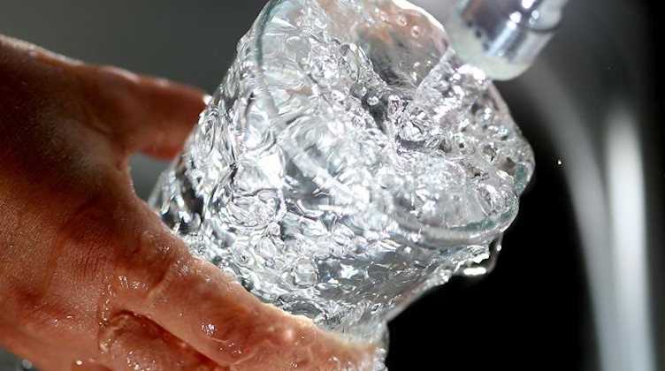 Trinkwasser läuft in ein Glas. Foto: picture alliance / Oliver Berg/dpa/Symbolbild