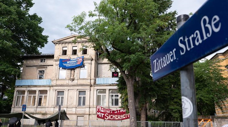 Transparente von Aktivisten hängen an der Fassade eines leerstehenden Wohnhauses. Foto: Sebastian Kahnert/dpa-Zentralbild/dpa