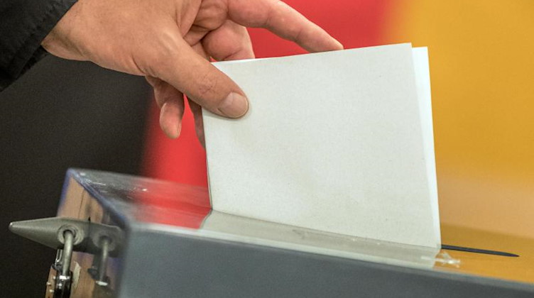 Ein Wähler wirft seinen Stimmzettel in eine Wahlurne. Foto: Michael Kappeler/dpa
