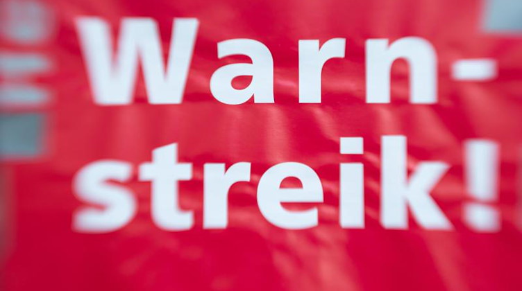 «Warnstreik!» steht auf einem Schild. Foto: Friso Gentsch/dpa/Symbolbild