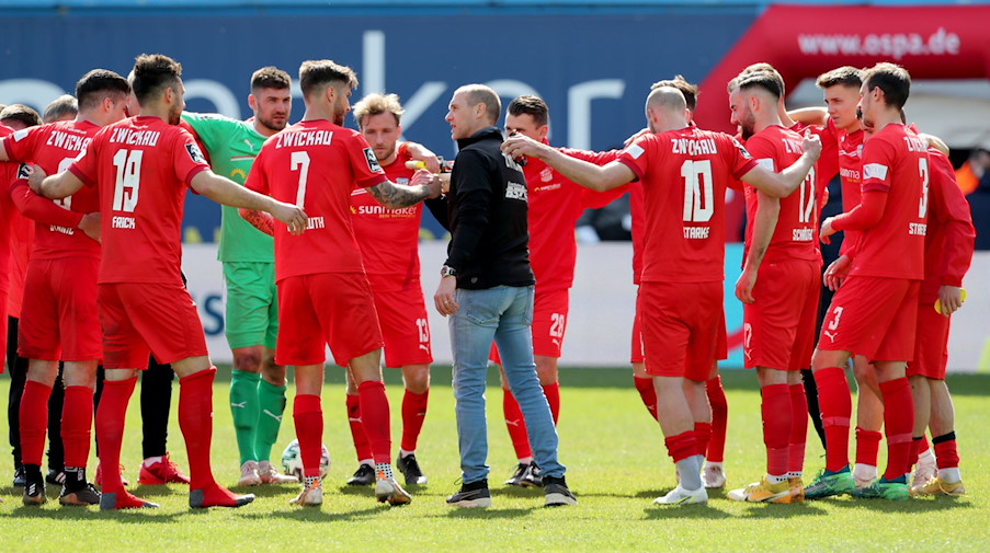 Die Zwickauer Spieler freuen sich nach einem Schlusspfiff mit ihrem Trainer Joe Enochs (M). / Foto: Bernd Wüstneck/dpa-Zentralbild/dpa/Archivbild