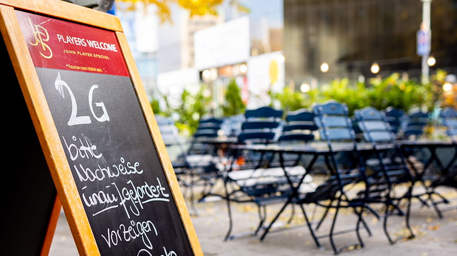 Ein Aufsteller auf der Terrasse eines Restaurants weist auf die 2G-Regel hin. / Foto: Moritz Frankenberg/dpa/Symbolbild