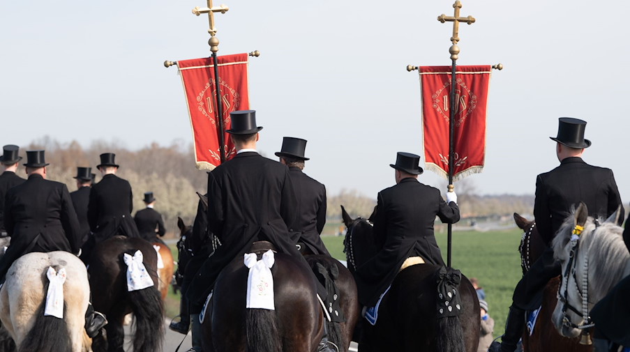 Die traditionell gekleideten sorbischen Osterreiter verkünden zu Pferde die Osterbotschaft. / Foto: Sebastian Kahnert/dpa