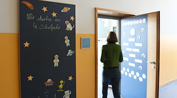 Die Schulleiterin einer Grundschule geht in ein Klassenzimmer. / Foto: Angelika Warmuth/dpa/Symbolbild