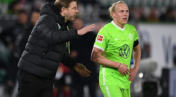 Wolfsburgs Trainer Florian Kohfeldt spricht mit Wolfsburgs Xaver Schlager. / Foto: Swen Pförtner/dpa/Archivbild
