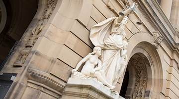 Vor einem Landgericht hält eine Statue der Justitia eine Waagschale. / Foto: Stefan Puchner/dpa/Symbolbild