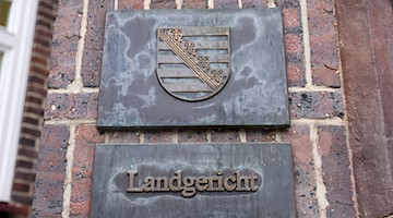 Ein Schild «Landgericht» und das sächsische Wappen hängen am Landgericht Chemnitz. / Foto: Jan Woitas/dpa-Zentralbild/dpa