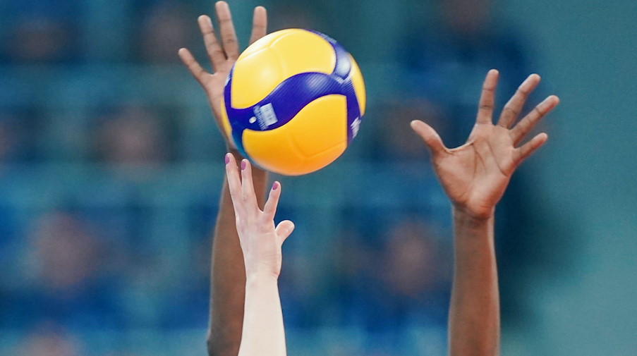 Spielerinnen strecken ihre Arme in Richtung eines Volleyballs. / Foto: Uwe Anspach/dpa/Symbolbild