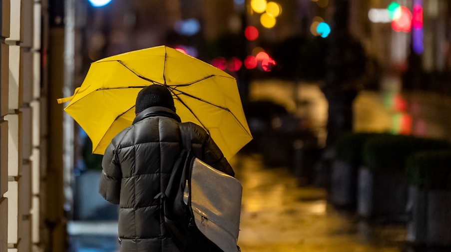 Ein Passant geht bei Regen durch die Stadt. / Foto: Peter Kneffel/dpa/Symbolbild