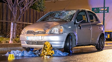 Ein Auto mit zersplitterter Frontscheibe steht auf der Straße. / Foto: André März/dpa