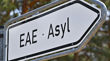 Die Abkürzung und das Wort «EAE Asyl» stehen auf einem Wegweiser zur Erstaufnahme-Einrichtungen. / Foto: Patrick Pleul/dpa/Symbolbild