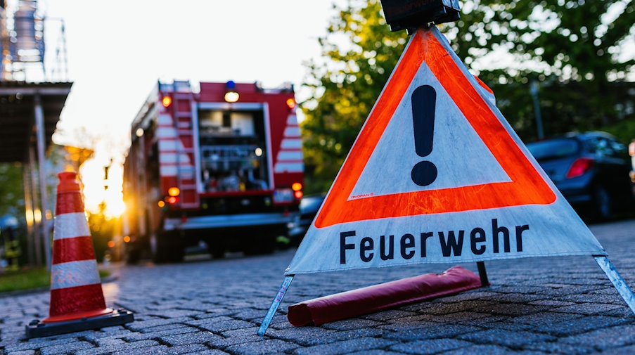 Ein Warndreieick mit der Aufschrift «Feuerwehr» steht auf dem Hof eines Feuerwehrgerätehauses. / Foto: Philipp von Ditfurth/dpa/Symbolbild