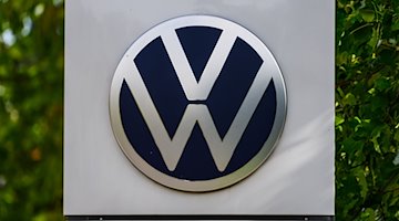 Логотип Volkswagen видно перед Прозорим заводом VW. / Фото: Robert Michael/dpa