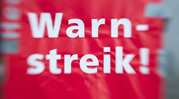 "¡Huelga de advertencia!" está escrito en un cartel / Foto: Friso Gentsch/dpa/Imagen simbólica