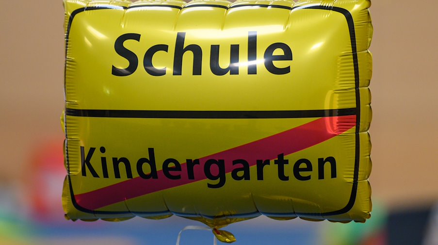 Ein Luftballon mit der Aufschrift "Schule" und einem durchgestrichenen "Kindergarten". / Foto: Robert Michael/dpa-Zentralbild/dpa/Symbolbild