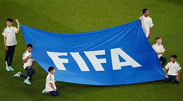 Kinder halten ein Banner mit der Aufschrift "FIFA". / Foto: Mike Egerton/Press Association/dpa