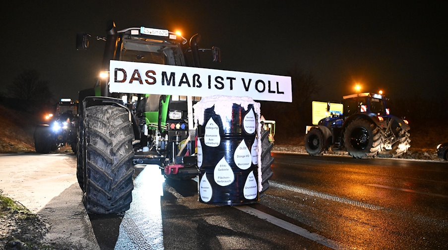 Mit Traktoren blockieren Landwirte die Zufahrt zur Autobahn. / Foto: Bernd Weißbrod/dpa