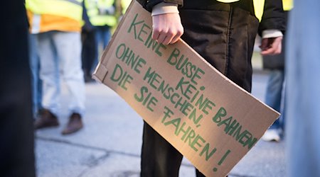Luisa Neubauer, activista climática, sostiene un cartel en el que se lee "¡Ni autobuses, ni trenes, sin gente que los conduzca!". / Foto: Sebastian Gollnow/dpa