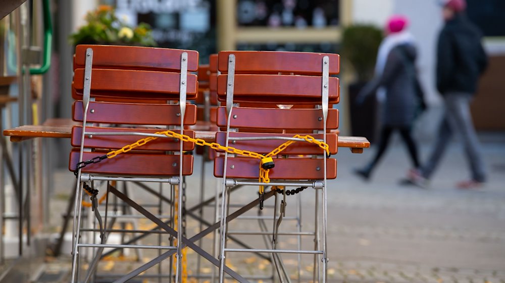 Tische und Stühle stehen vor einem Restaurant. / Foto: Sven Hoppe/dpa/Archivbild