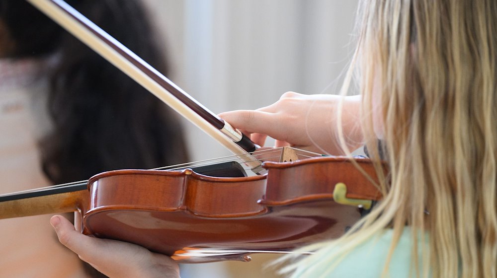 Дівчинка грає на скрипці / Фото: Robert Michael/dpa