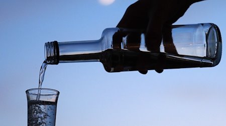 Ein Mann gießt am Abend aus einer Flasche Schnaps in ein Glas. Alkohol bleibt in Sachsens Suchtberatungsstellen das häufigste Thema. / Foto: Soeren Stache/dpa-Zentralbild/dpa/Archivbild