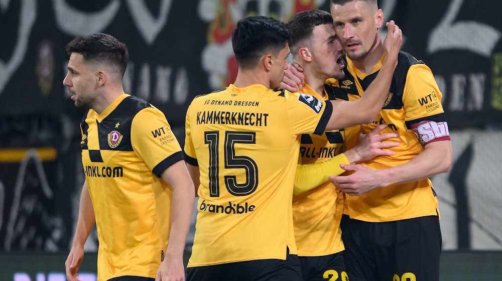 Dynamo's Stefan Kutschke (r) celebrates after his goal for 1:0 with Ahmet Arslan (l-r), Claudio Kammerknecht and Dennis Borkowski / Photo: Robert Michael/dpa