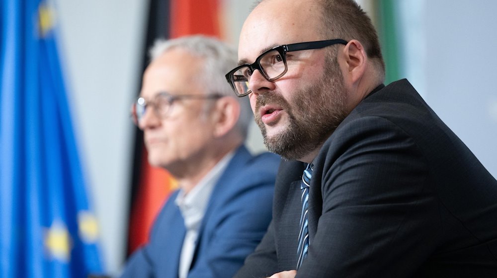 Christian Piwarz (CDU, derecha), Ministro de Cultura de Sajonia, habla en una rueda de prensa del gabinete / Foto: Sebastian Kahnert/dpa