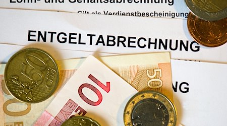 Auf Abrechnungsformularen liegen Euromünzen und -Geldscheine. / Foto: Arno Burgi/dpa-Zentralbild/dpa/Symbolbild