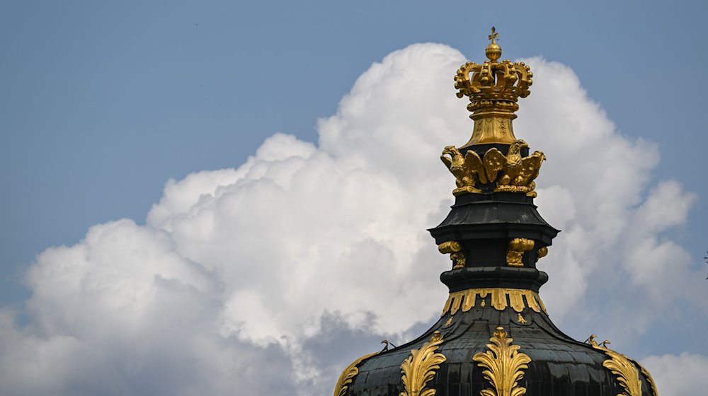 Wolken ziehen hinter dem Kronentor des Dresdner Zwingers am Himmel auf. / Foto: Robert Michael/dpa