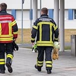 Zwei Feuerwehrmänner laufen auf dem Areal der Landesfeuerwehr- und Katastrophenschutzschule in Nardt entlang. / Foto: Daniel Schäfer/dpa-Zentralbild/dpa