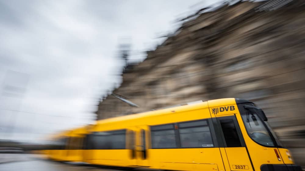 Eine Straßenbahn der Dresdner Verkehrsbetriebe (DVB) fährt am Nachmittag über den Theaterplatz. / Foto: Robert Michael/dpa