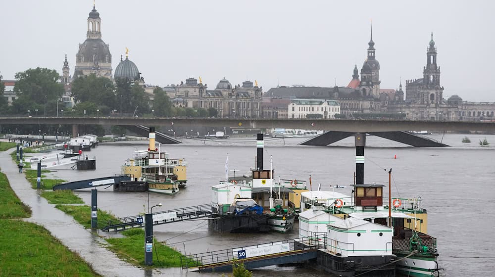 Po rěce horje ležace historiske kolesowarske parniki Běłeje floty w Drježdźanach, w pozadku wobškodźeny Carolowy móst a stare město. (Archivbild) / Foto: Robert Michael/dpa